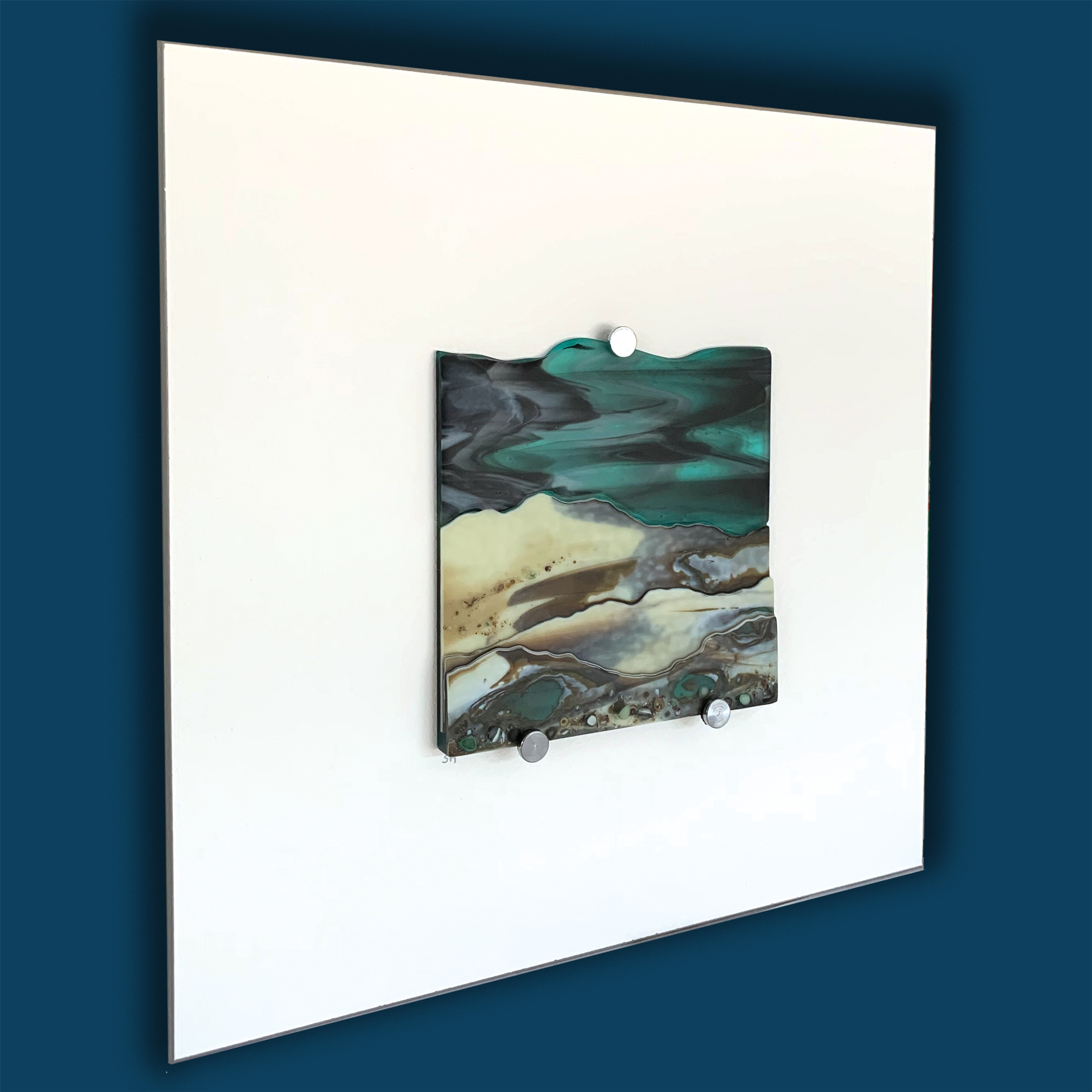 Glass Wall Art, welsh coastline with moody aquamarine sky, vanilla/greens/grey landscape.