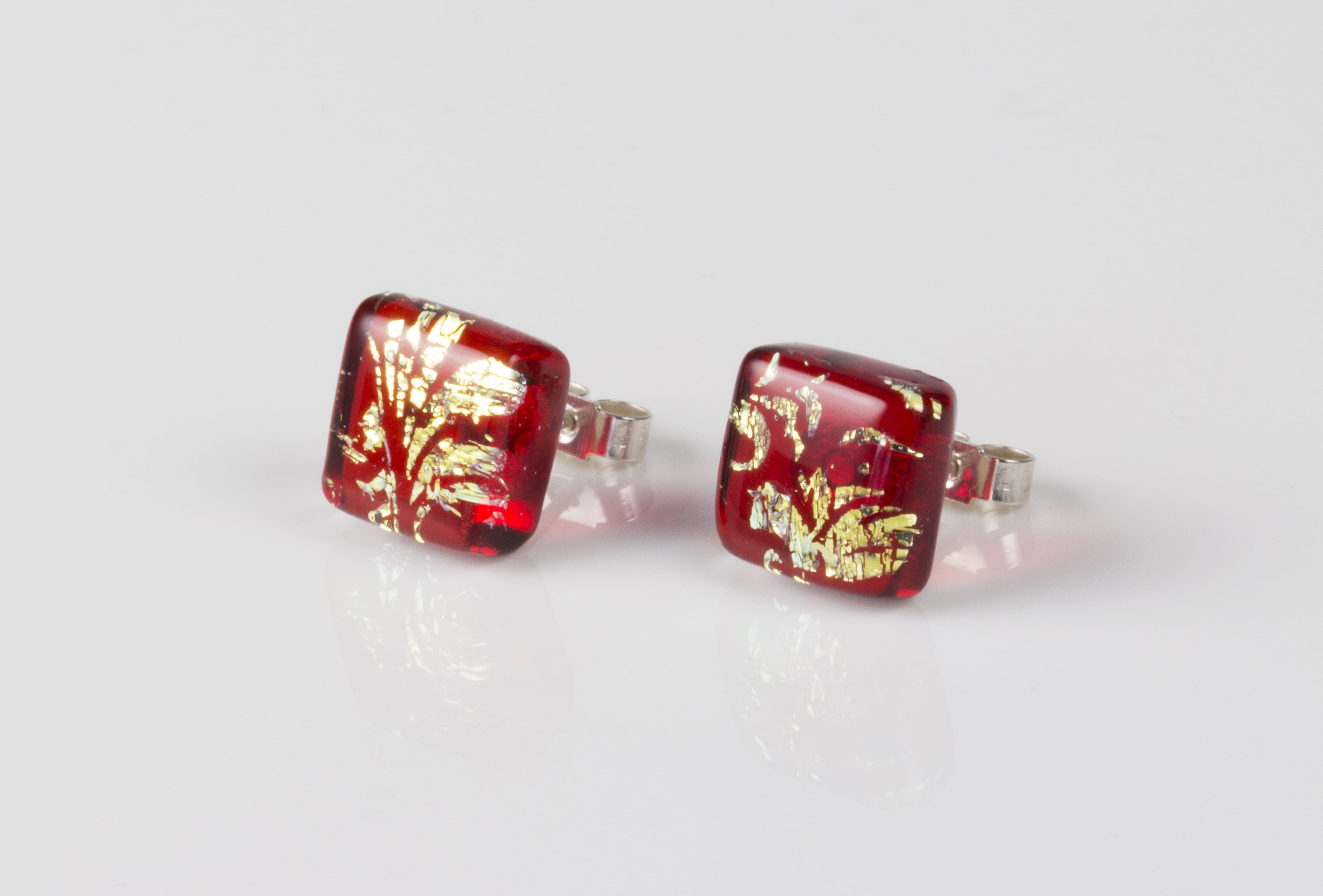 Dichroic glass jewellery uk, handmade stud earrings - red topped with gold plume pattern. Square, glass 8-11mm, sterling silver