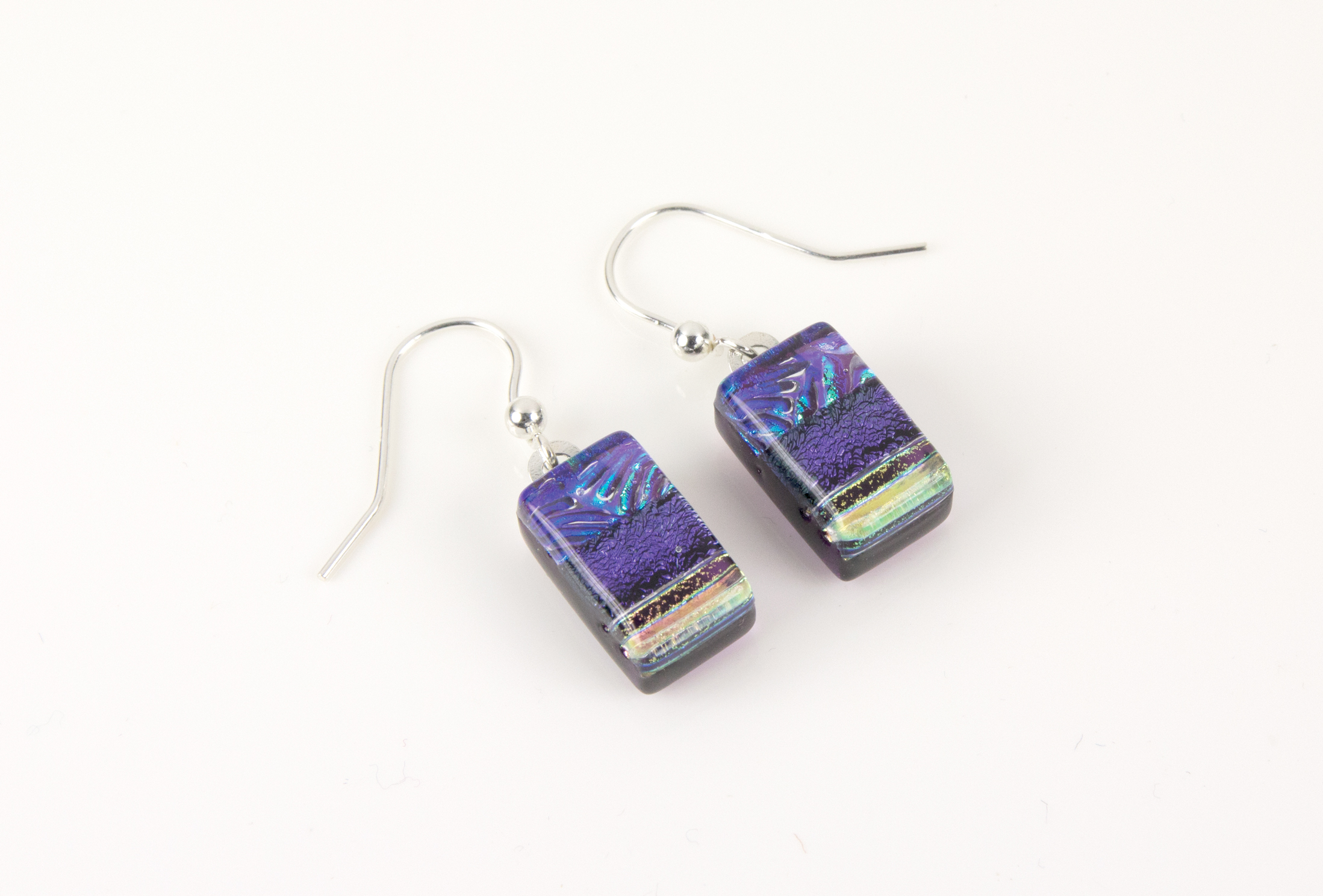 Dichroic glass jewellery, glass drop earrings, violet glass earrings with starburst pattern and lines, art glass earrings, handmade in Shropshire, sterling silver hooks