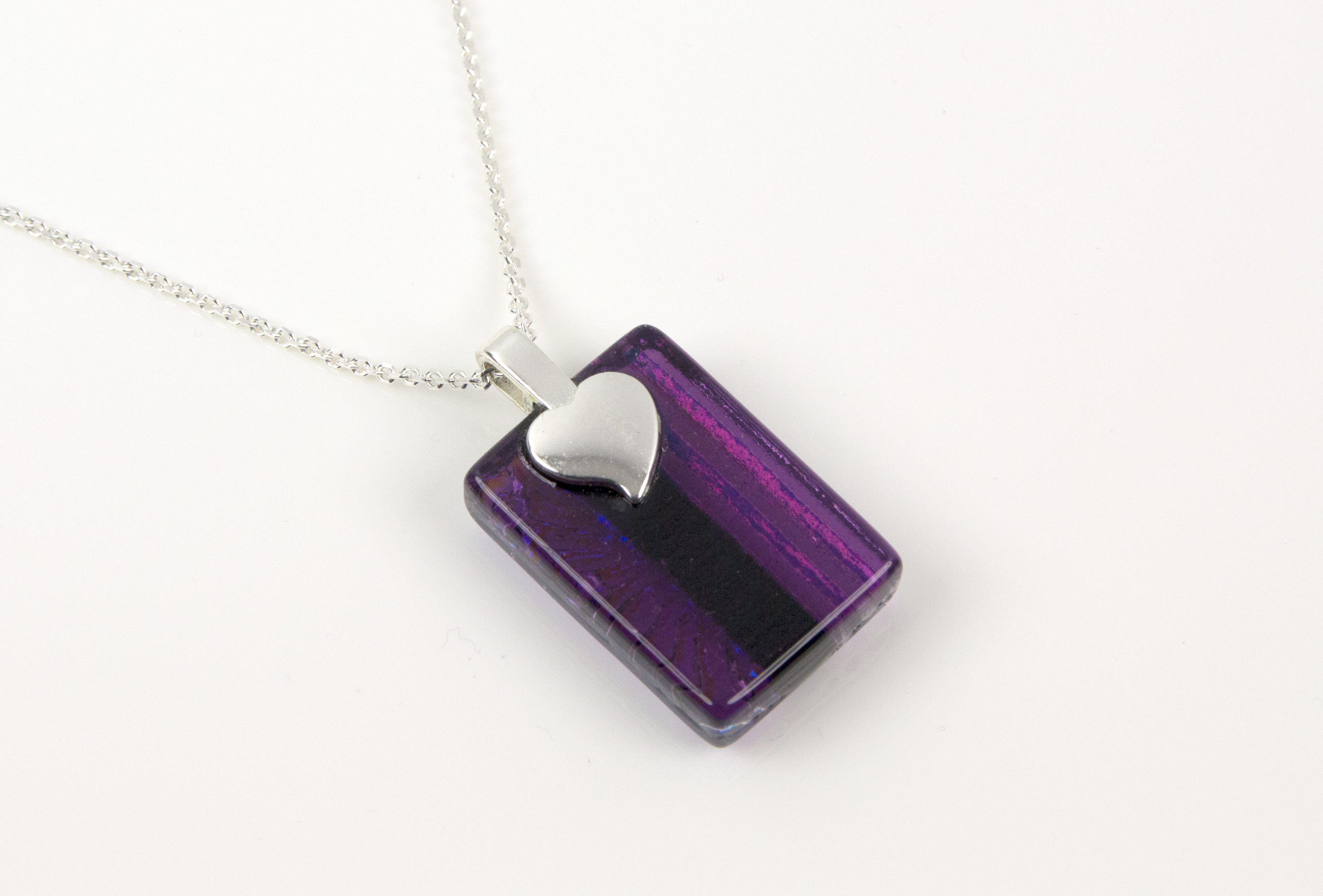 Handmade glass pendant necklace with a clear violet base and a mix of subtle dichroic starburst and textured lines, divided by bold violet dichroic. Sterling silver 16-18" chain.