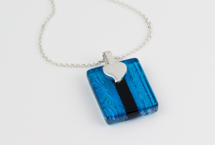 Handmade glass pendant necklace with a clear turquoise base and a mix of subtle dichroic starburst and textured lines, divided by a bold pale blue. Sterling silver 16-18" chain